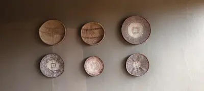 a bunch of plates hanging on a wall at Dar Amane Guest House in Graskop