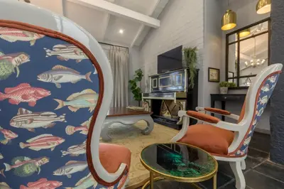 a living room with a fish wallpaper at La Roca Guest House in Nelspruit