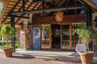 a building with an open door with potted plants at Kruger Park Lodge Unit No. 509 in Hazyview