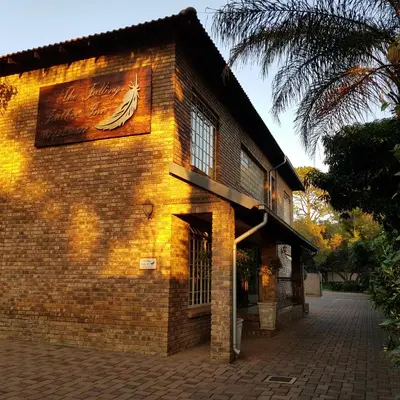 a brick building with a painting of a boat on it at Falling Feather Inn in Pretoria