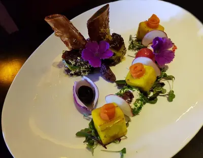 a white plate of food on a table at Fusion Boutique Hotel in Polokwane