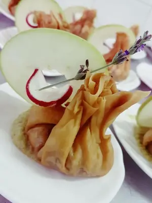a plate of food with a knife on top of food at Fusion Boutique Hotel in Polokwane
