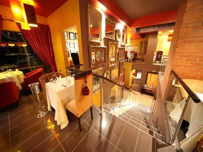 a restaurant with a table and a dining room at Fusion Boutique Hotel in Polokwane