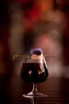 a glass of wine with a stick in it at Fusion Boutique Hotel in Polokwane