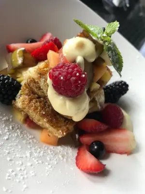 a plate of food with fruit on it at Fusion Boutique Hotel in Polokwane
