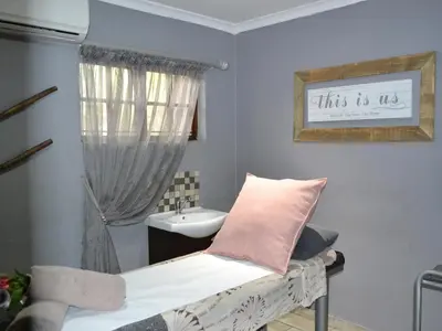 a small bathroom with a bed and a sink at Mount Amanzi in Hartbeespoort