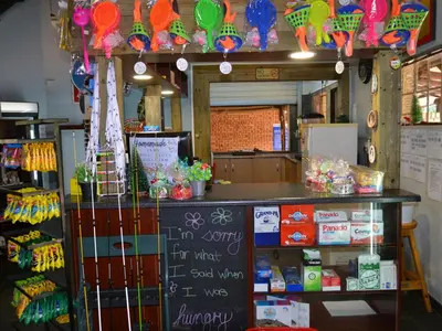 a store with a counter with a chalkboard in a room at Mount Amanzi in Hartbeespoort