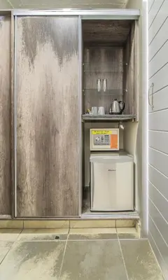 a kitchen with a refrigerator and a microwave at Hotel 224 & Apartments in Pretoria