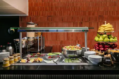 a buffet of food on a counter in a kitchen at Hotel 224 & Apartments in Pretoria