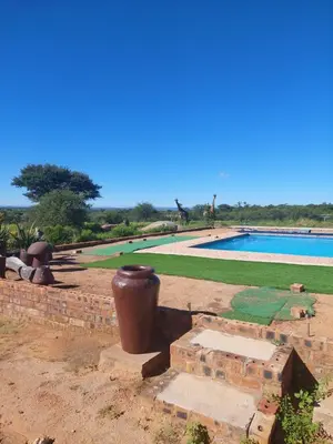 a large vase sitting next to a swimming pool at Karibu River Retreat in Marble Hall