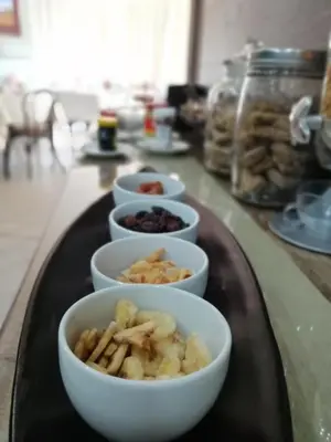 a tray with bowls of food on a counter at Diamond Rose Guest House in Middelburg