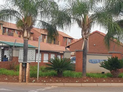 two palm trees in front of a building at Clearwater Self catering Apartments No Loadshedding in Centurion