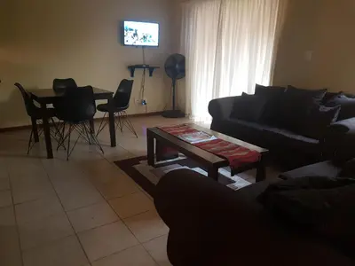 a living room with a couch and a table at Clearwater Self catering Apartments No Loadshedding in Centurion