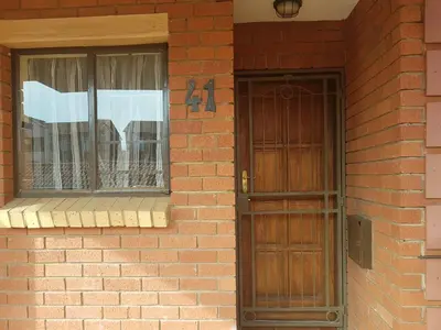 a brick building with a door and a window at Clearwater Self catering Apartments No Loadshedding in Centurion