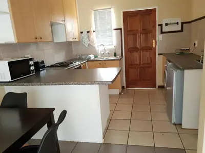 a kitchen with a counter top and a refrigerator at Clearwater Self catering Apartments No Loadshedding in Centurion