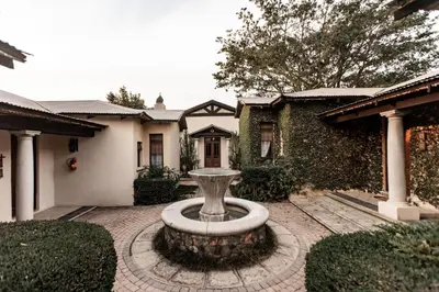 a fountain in the courtyard of a house at Dawsons Game Lodge in Badplaas