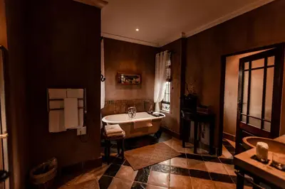 a bathroom with a sink and a bath tub at Dawsons Game Lodge in Badplaas