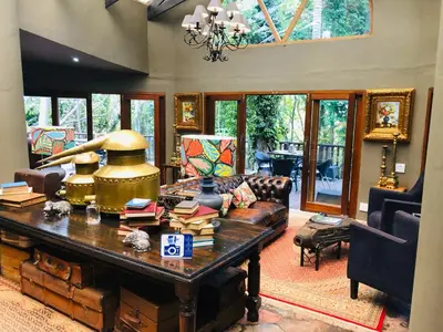 a living room with a couch and a table at Shangri-La Country Hotel & Spa in Modimolle