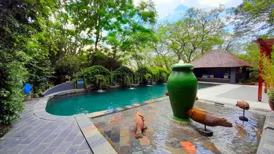 a green vase in the middle of a swimming pool at Shangri-La Country Hotel & Spa in Modimolle