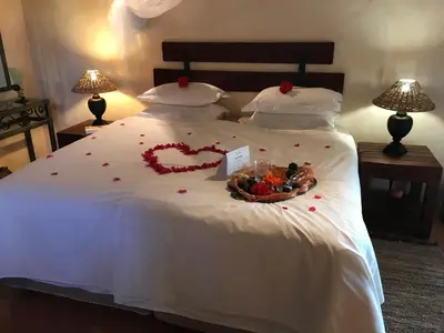 a bed with a heart made of flowers on it at Weltevreden Country Guest Lodge in Groblersbrug
