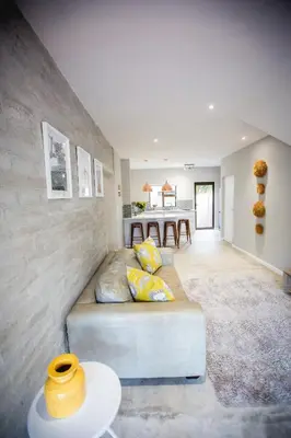 a living room with a couch and a table at Maya Manor in Hoedspruit