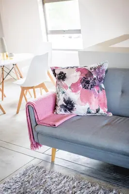 a couch with a pillow on it in a living room at Maya Manor in Hoedspruit