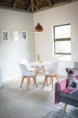 a living room with a table and chairs at Maya Manor in Hoedspruit