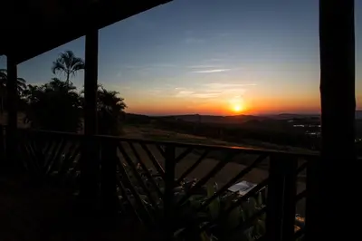 a sunset from the balcony of a house at Nabana Lodge in Hazyview