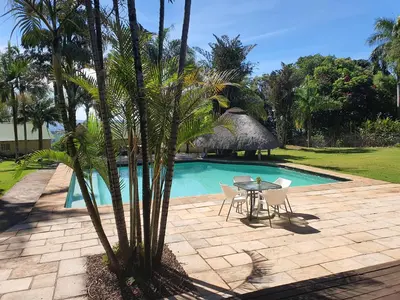 a patio with a table and chairs next to a pool at Nabana Lodge in Hazyview