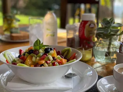 a bowl of fruit salad sitting on a table at Nabana Lodge in Hazyview