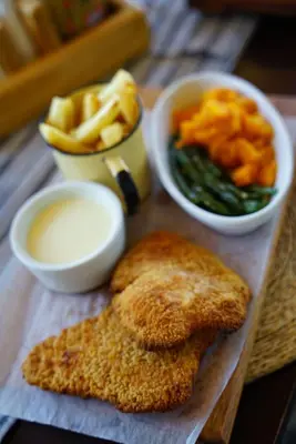 a plate of food with chicken and dip and french fries at Nabana Lodge in Hazyview