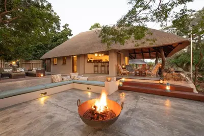 a patio with a fire pit in front of a house at Nyala Safari Lodge in Hoedspruit