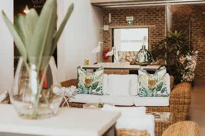 a living room with a couch and a mirror at Execustay in Nelspruit