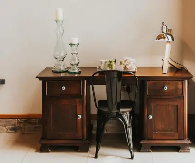 a wooden desk with a chair and a table with lamps at Execustay in Nelspruit