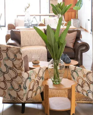 a living room with a couch and a vase with a plant at Execustay in Nelspruit