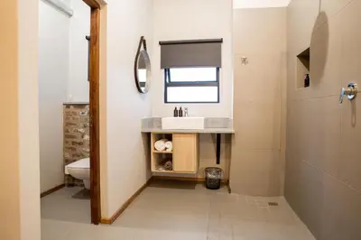 a bathroom with a sink and a toilet at Execustay in Nelspruit