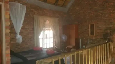 a room with a window and a brick wall at Marlothii Safari House in Marloth Park