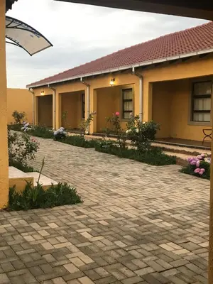 a house with a brick driveway in front of it at Kanyane Lodge in Jane Furse