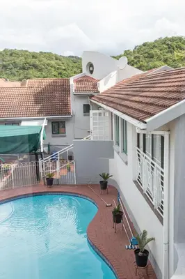 a swimming pool in front of a house at 29 Polvy Street in Nelspruit