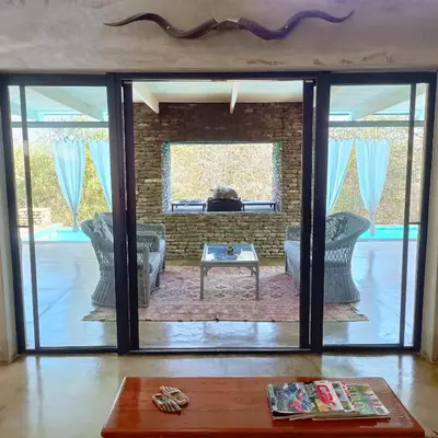 a living room with a large glass door at Kruger River Villas - LionsGate in Marloth Park