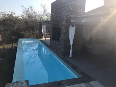 a swimming pool in the backyard of a house at Kruger River Villas - LionsGate in Marloth Park