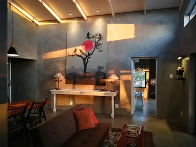 a living room with a couch and a table at Kruger River Villas - LionsGate in Marloth Park
