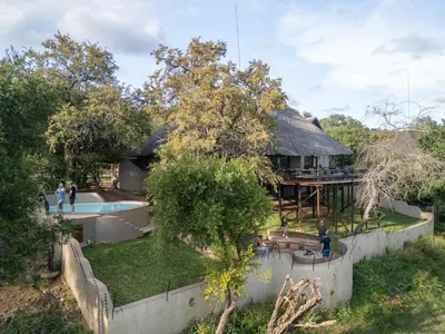 an aerial view of a house with a pool and a yard at Nyati Safari Lodge in Hoedspruit