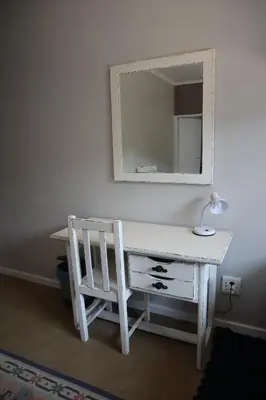 a white desk with a chair and a mirror at Rocks & Roses Farm stay in Lochiel