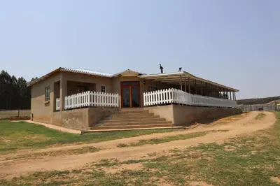a small house on a dirt road at Rocks & Roses Farm stay in Lochiel
