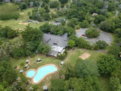 an aerial view of a house with a swimming pool at Kruger Park Lodge in Hazyview