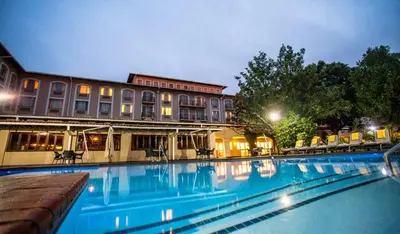 a large swimming pool in front of a building at Garden Court OR Tambo International Airport in Kempton Park