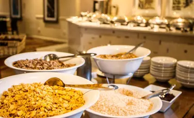 a group of bowls of food on a table at Garden Court OR Tambo International Airport in Kempton Park