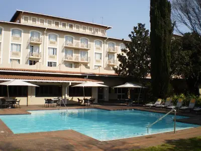 a large swimming pool in front of a hotel at Garden Court OR Tambo International Airport in Kempton Park
