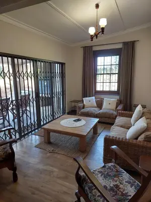 a living room with a couch and a coffee table at De Mist Graskop in Graskop